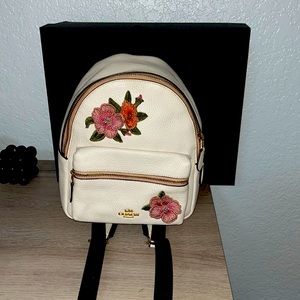 mini white floral coach backpack with minor stain on inside fabric